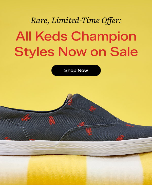 A sunny yellow background with overlaid text that says Rare, Limited-Time Offer: All Keds Champion Styles Now on Sale. Shop Now. A close-up side view of the Keds Champion Round Toe Nautical Canvas Slip-On in navy with red lobster print. The sneaker is sitting on a yellow-and-white striped beach towel.