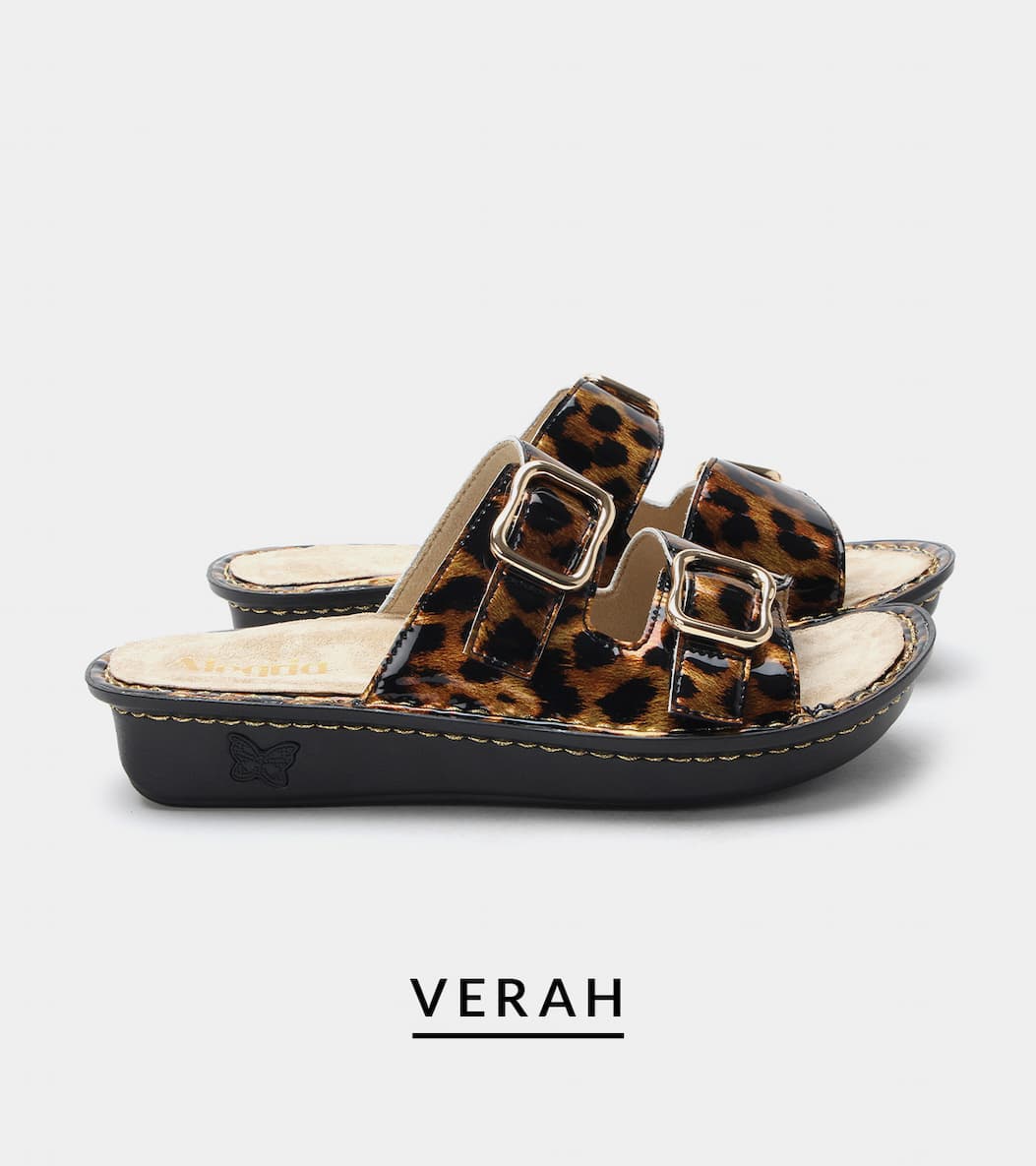 Pair of glossy leopard print double-strap slide sandals with gold buckle closures, light tan footbeds, and thick black soles. Product name "VERAH" displayed below on a light gray background.
