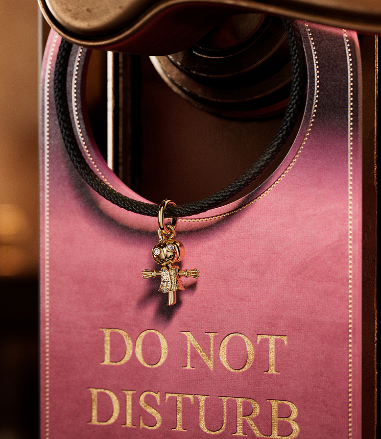 A door hanger with a scarecrow Pandora charm
