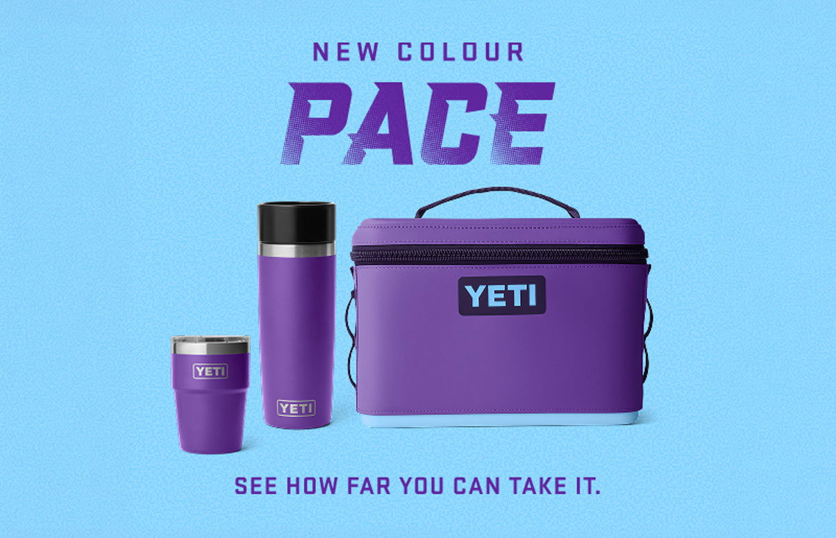 Purple YETI cooler, bottle and tumbler in the new Pace colour against a blue background.