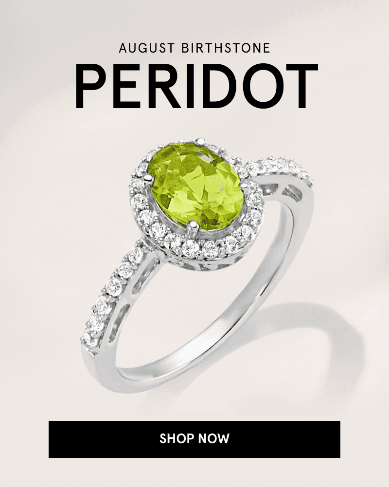 A silver ring with an oval green peridot gemstone and diamond halo setting. August birthstone peridot. Click shop now.