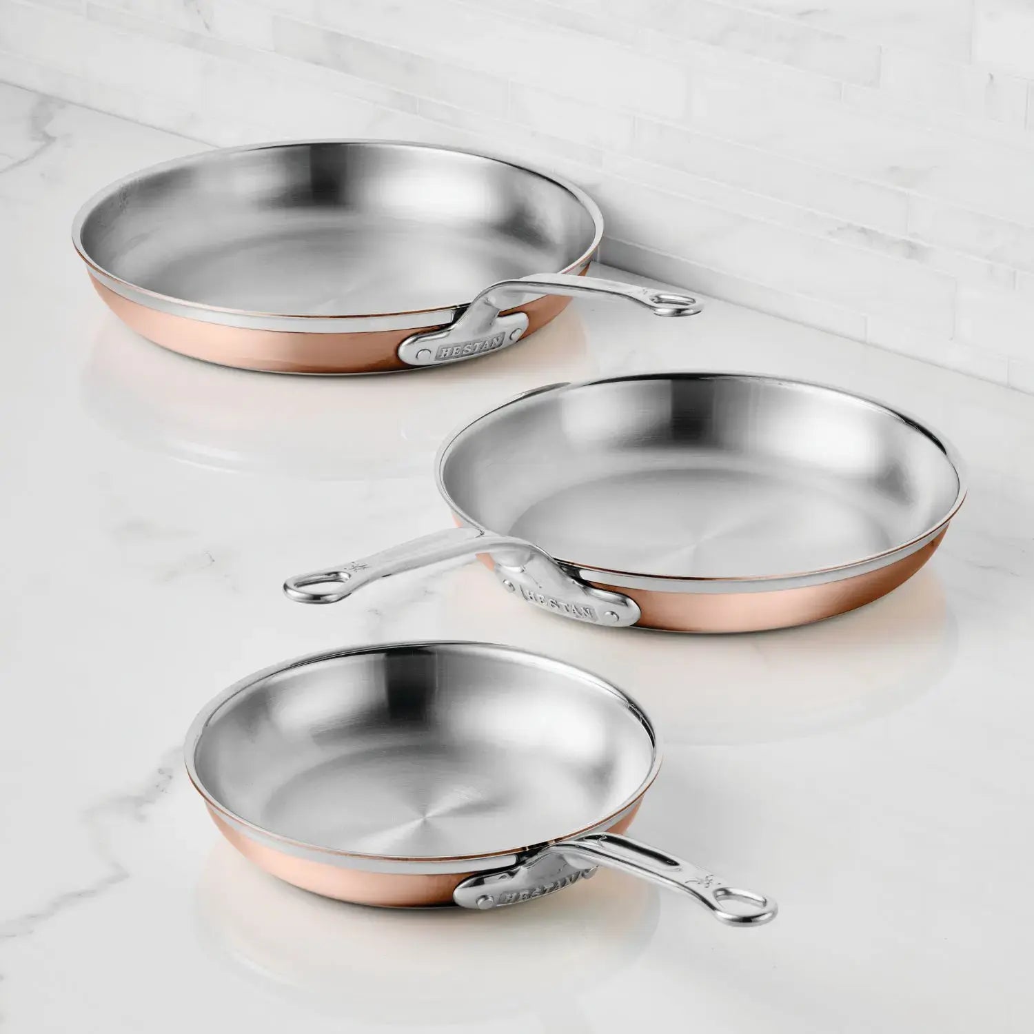 IMG: Copper Induction Skillets on marble countertop