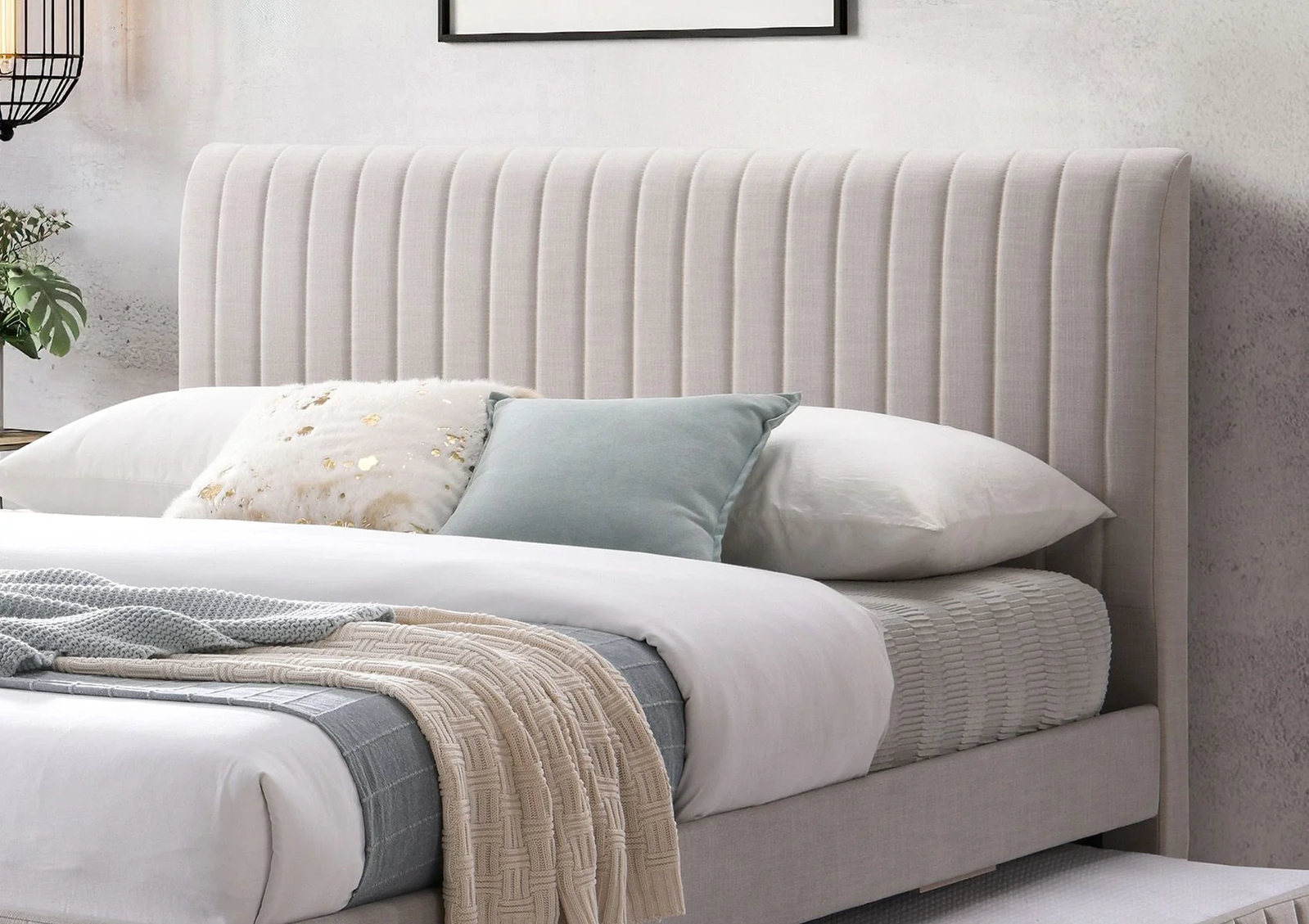 A close up of a grey fabric headboard.
