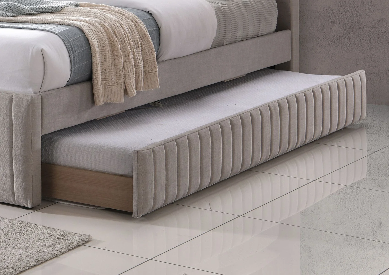 A grey fabric bed opening, showcasing another, smaller bed. 