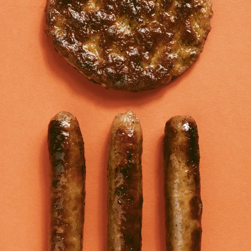 A sausage patty and three sausage links.