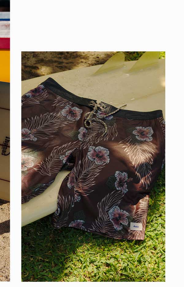 Mallow Hybrid Trunks laying out on surfboard