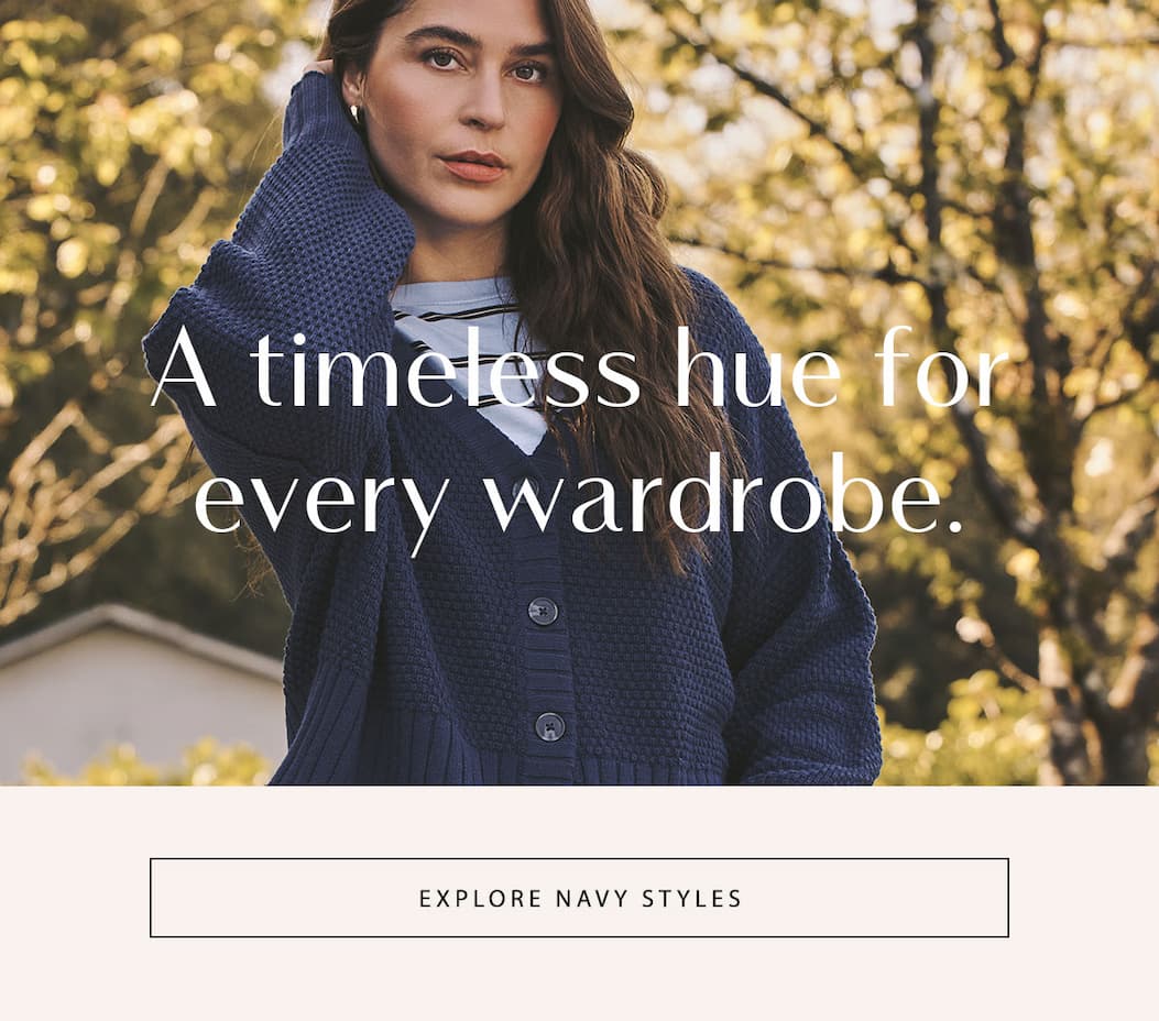 Model in a navy cardigan with "A timeless hue for every wardrobe" and an "Explore Navy Styles" button.