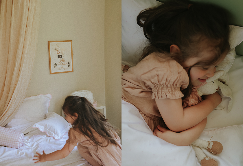 girl clutching bunny in bed