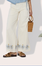 Hibiscus Wave 5-Pocket Pants - cut in soft stretch twill, fitted at the hips with a wider leg that drapes easy. A fixed waist, zip fly, and wrap-around patch pockets keep things classic, while delicate embroidery at the hem