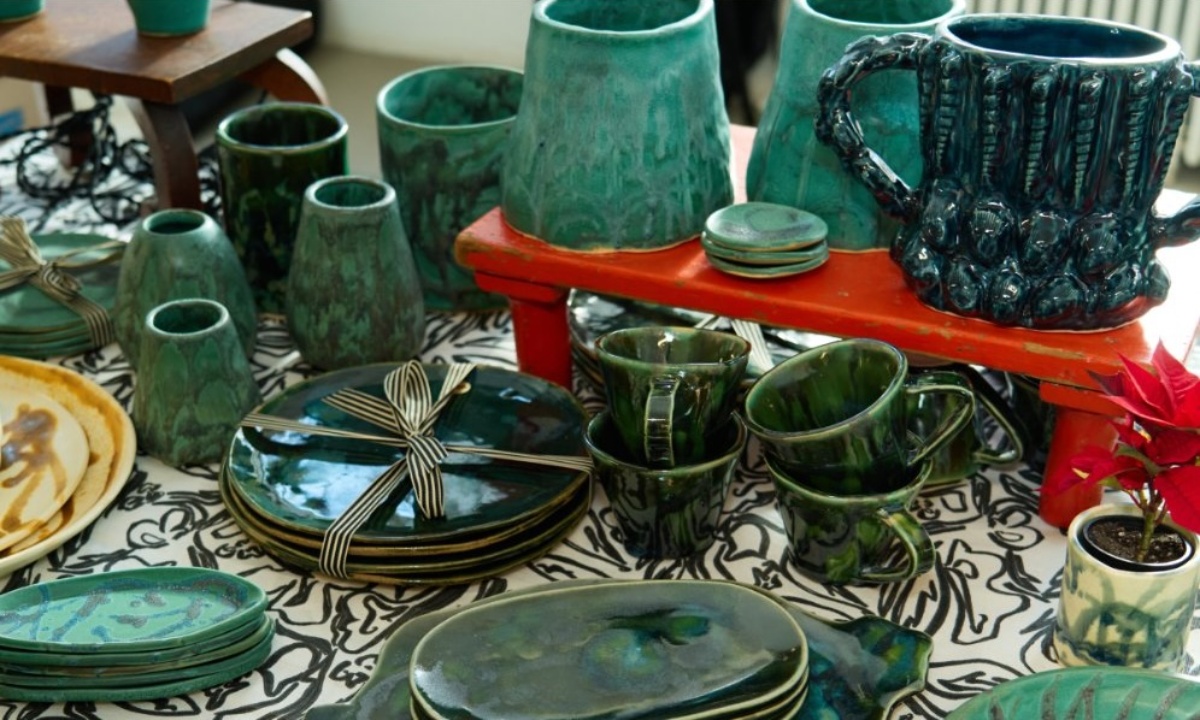 Holiday MRKT event details with festive tableware display in green and gold.