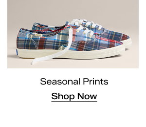 A side view of the Keds Champion Classic Plaid Lace-Ups in blue/red which were $59.95 and are now $41.99 for a limited time. Text under the sneakers says Seasonal Prints. Shop Now.