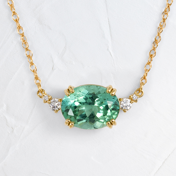 The Pictorial Necklace, 1.86ct. Green Afghanistan Tourmaline shown on a textured white background