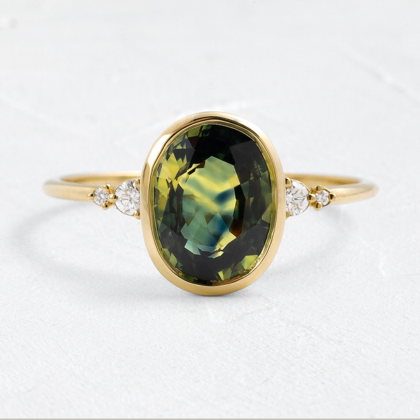 The Bezel Pictorial Ring, 2.57ct. Bicolor Yellow and Green Sapphire shown on a textured white background