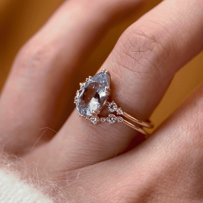 The Pictorial Ring, 1.96ct. Light Blue Sri Lanka Sapphire and the Pictorial Curved Band shown being worn by a model