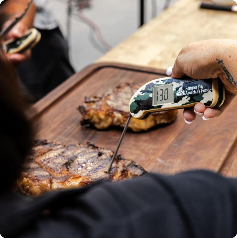 Camo Thermapen Temping Steak on Cutting Board