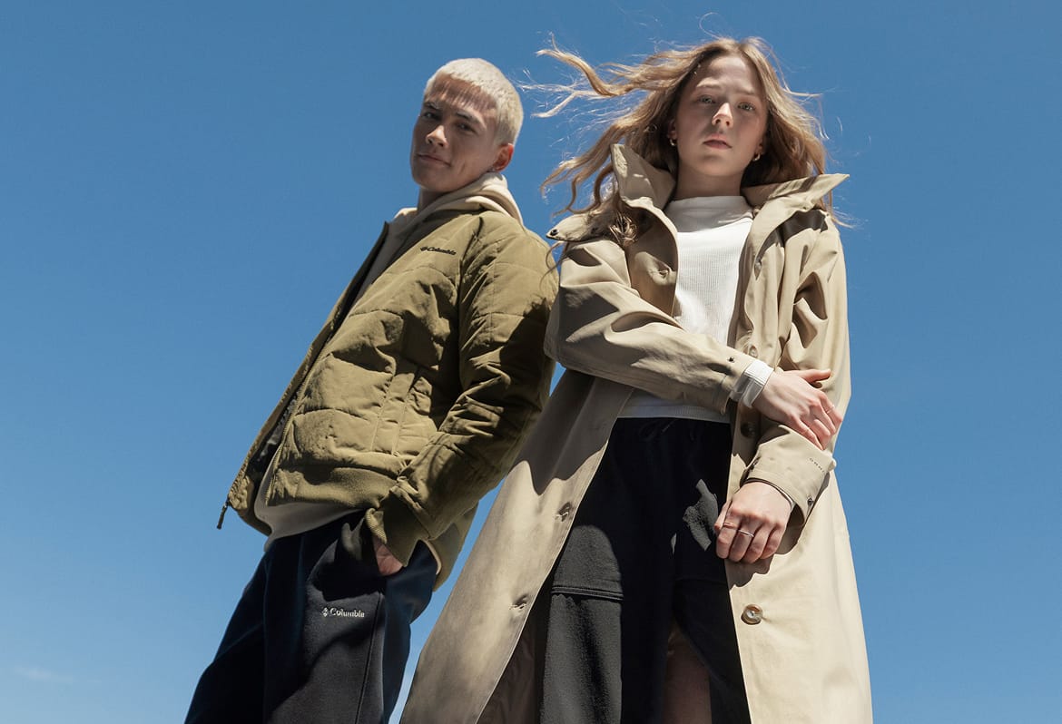 A man and a woman standing with blue sky in the background