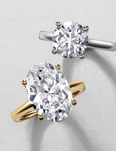 Yellow gold oval-cut and white gold round-cut diamond solitaire rings.