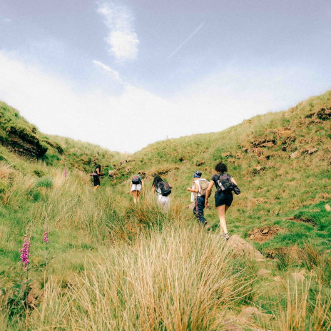 People hiking a trail in the Peak District.