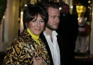 Socialite Ghislane Maxwell with an unidentified male companion attends the Opening of the Asprey Flagship Store on 5th Avenue December 8, 2003 in New York City.