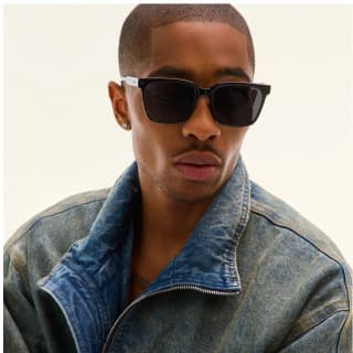 Image of man wearing square black sunglasses looking to the side