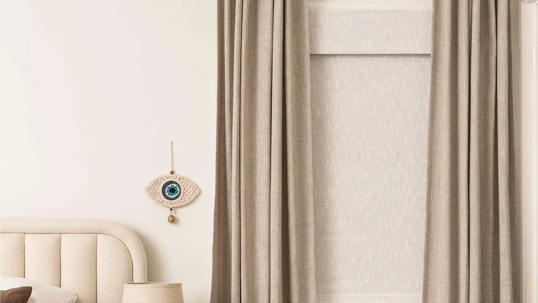 Curtarra custom curtains and woven shade styled in a bedroom