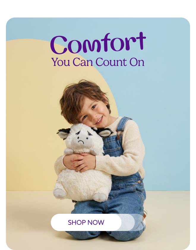 A little boy hugging Moody Moo Warmies. Shop Now.
