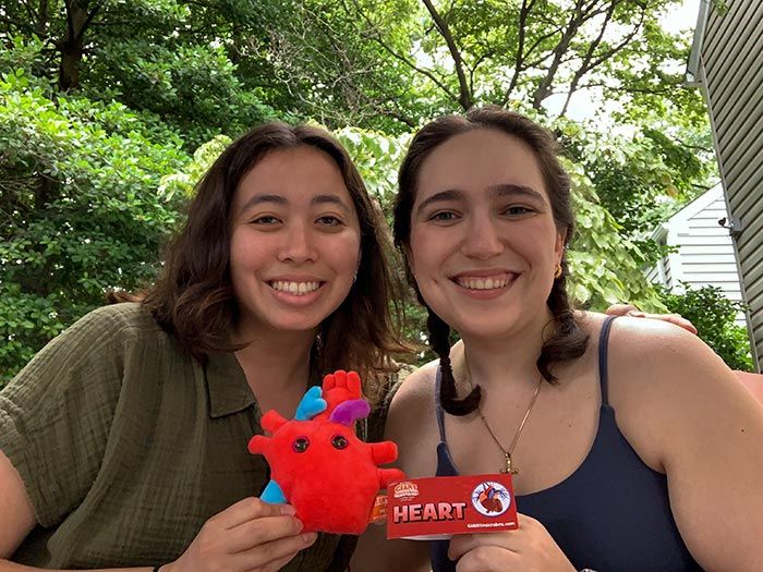 Girls sharing Heart plush