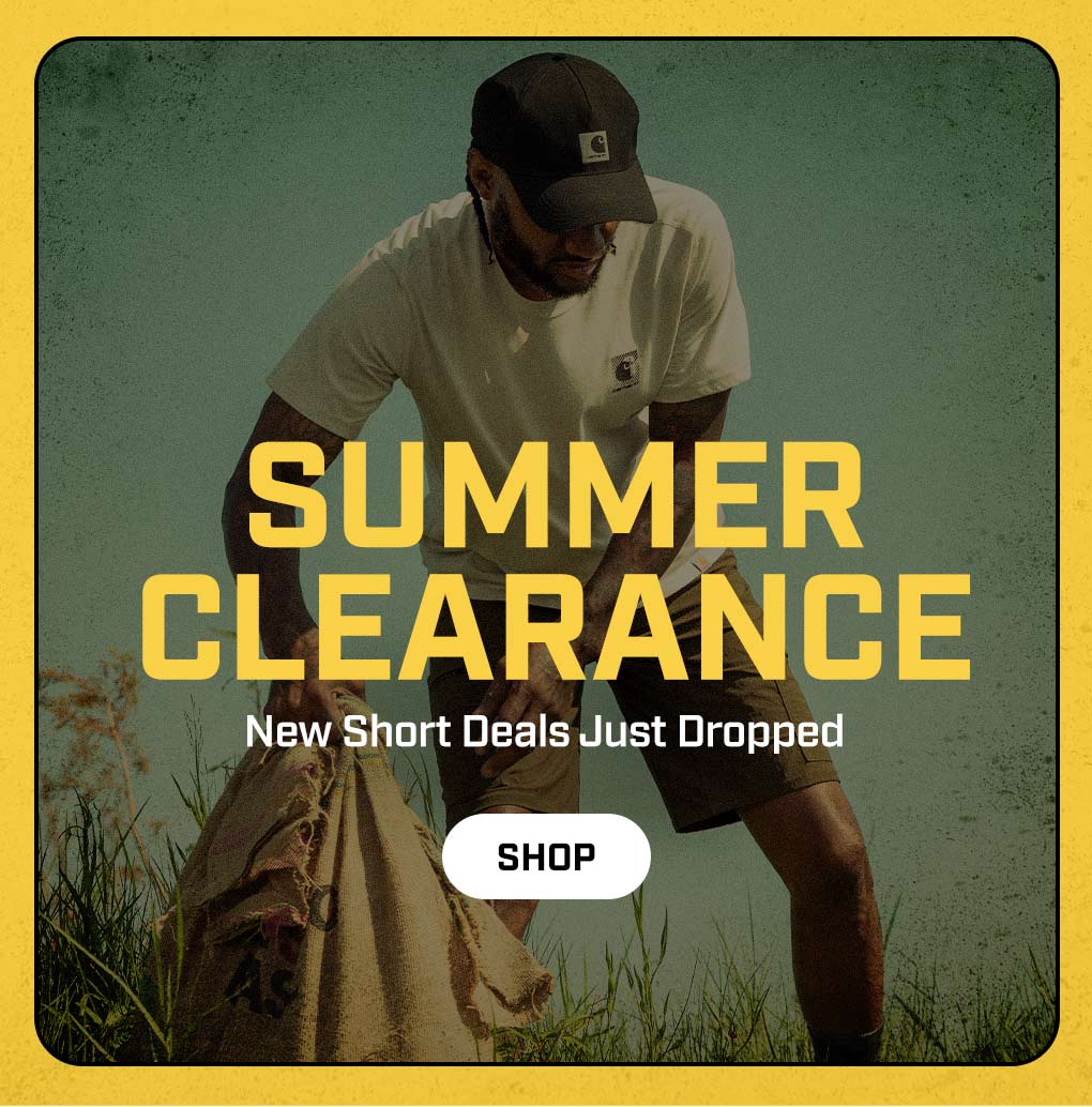 A man working outside in the heat wearing carhartt t-shirt and shorts