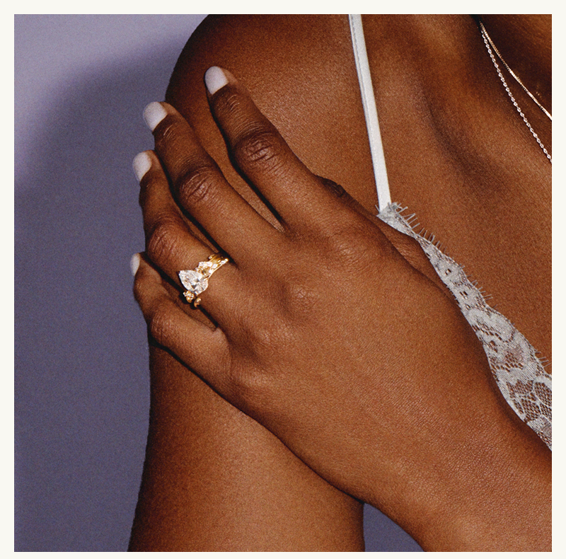 Model’s focus on pear-shaped diamond ring.