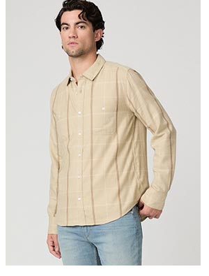 A man wearing a beige plaid flannet.