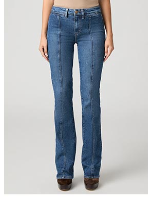 A woman's legs in slim fitting bootcut blue denim jeans.