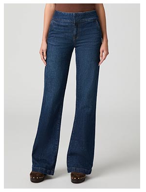 A woman's legs wearing dark blue wide leg denim jeans.