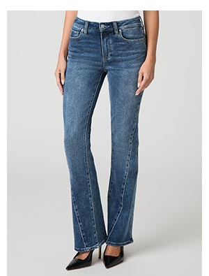 A woman's legs wearing rinsed blue denim jeans with bootcut flare.