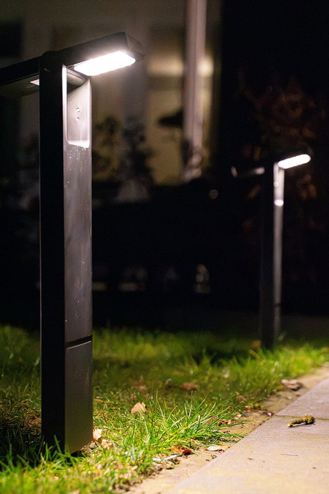 Set of 2 Alton solar-powered LED path lights in black with ground spikes. These modern solar-powered garden lights emit a warm white glow and are ideal for illuminating garden paths, flowerbeds, driveways and patios. They are powered entirely by solar energy and switch on automatically at dusk – providing atmospheric and energy-efficient outdoor lighting.