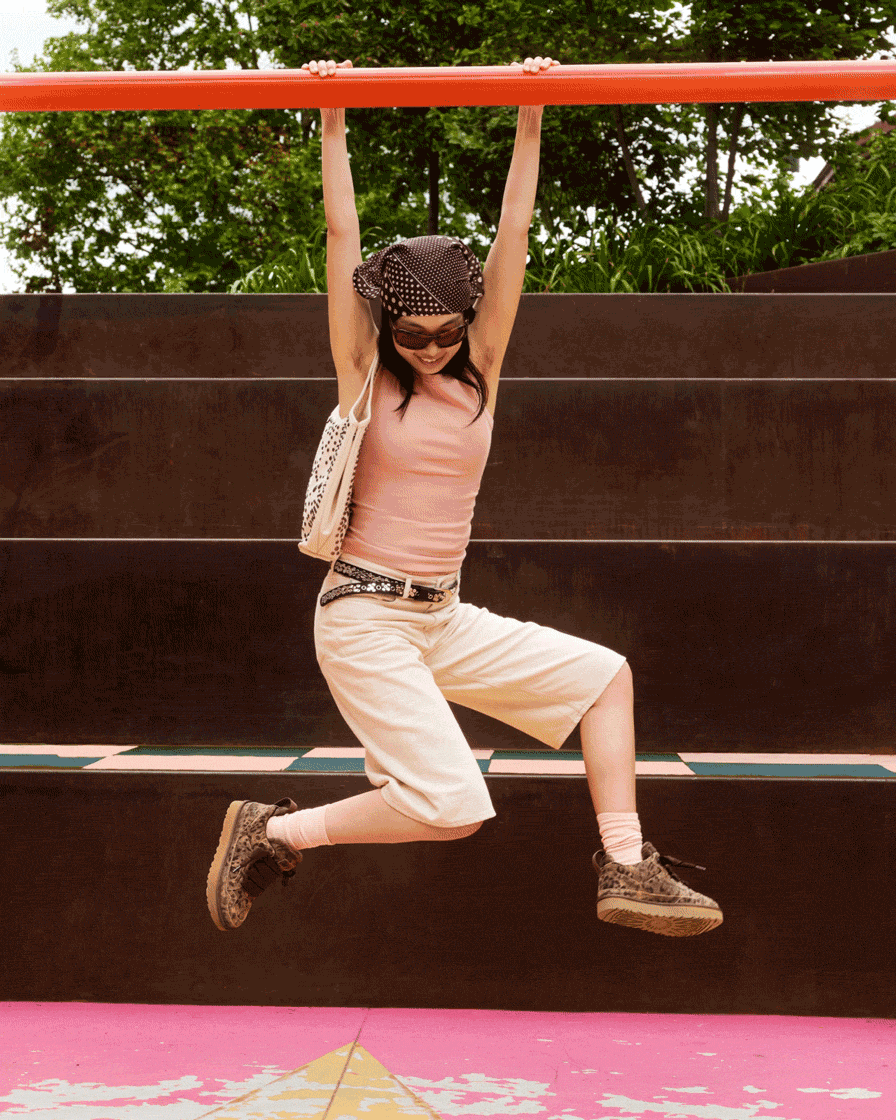 Gif of a person hanging from a beam, wearing the spotted Lowmel trainers.