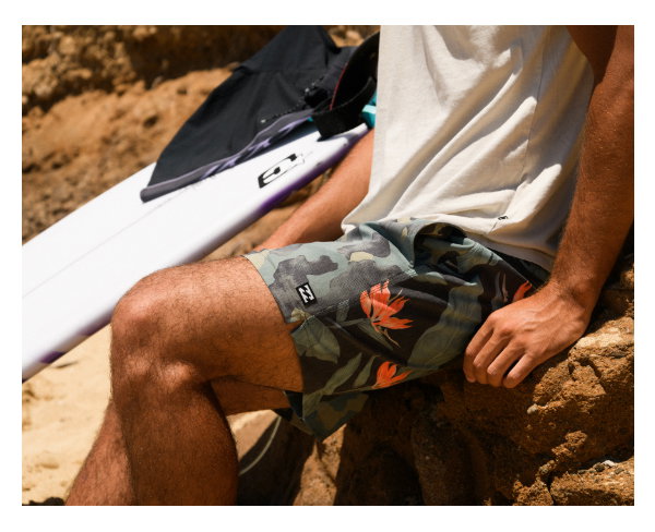 Male Billabong surfer watching the waves wearing printer boardshorts.