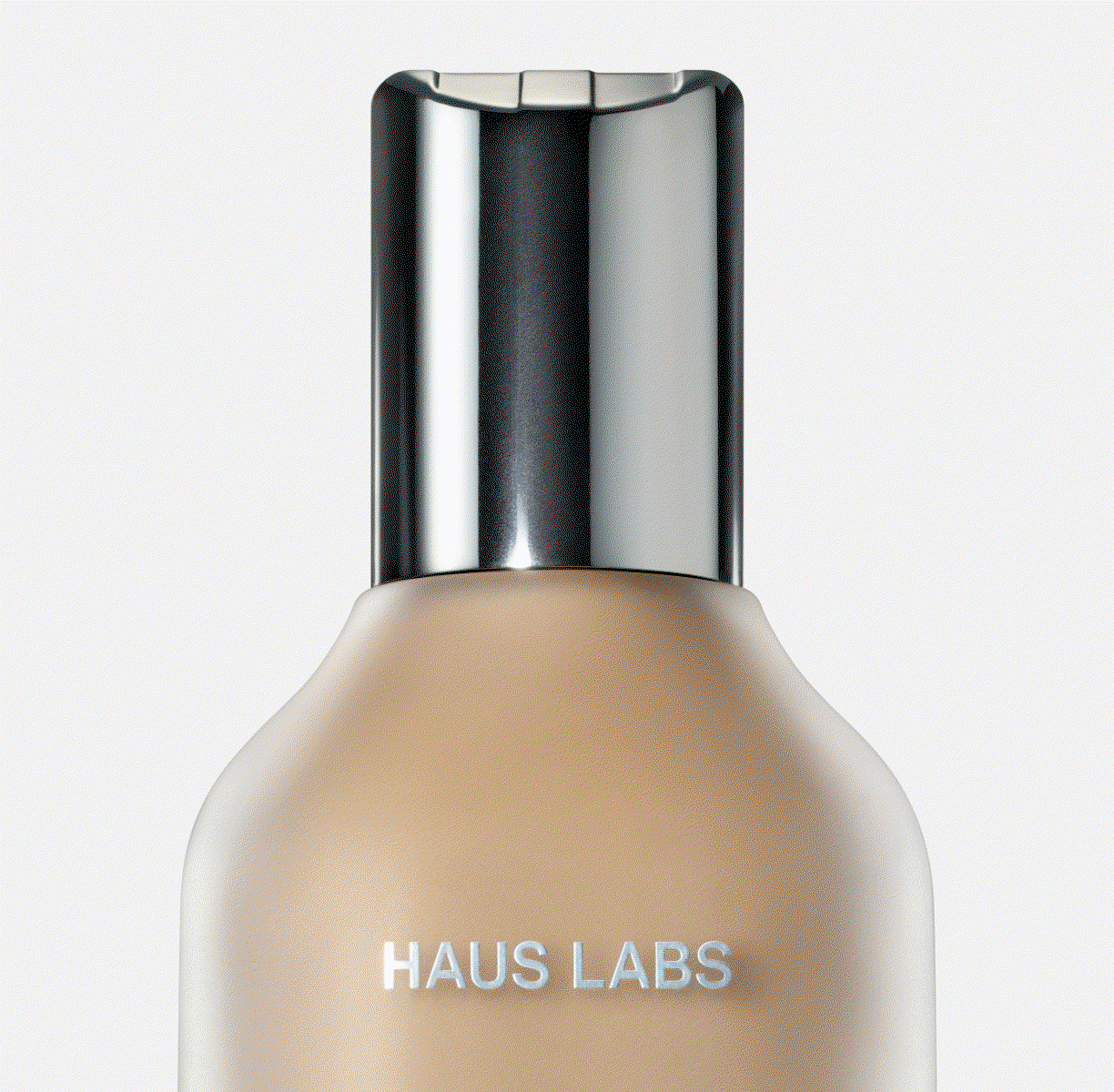 Animated carousel of close-up Haus Labs products, including foundation, concealer, ruby and sheer petal lip lacquer, a makeup brush, and mascara, each centered against a light gray background.