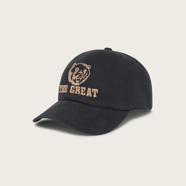 The Baseball Hat. Graphic -- Black by THE GREAT. F25 D1 ACCESSORIES features chainstitch embroidery of a bear head and "THE GREAT" in tan on the front.