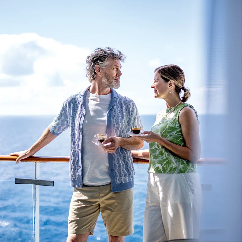 Relaxing on deck with drinks, enjoying ocean views aboard a cruise ship.
