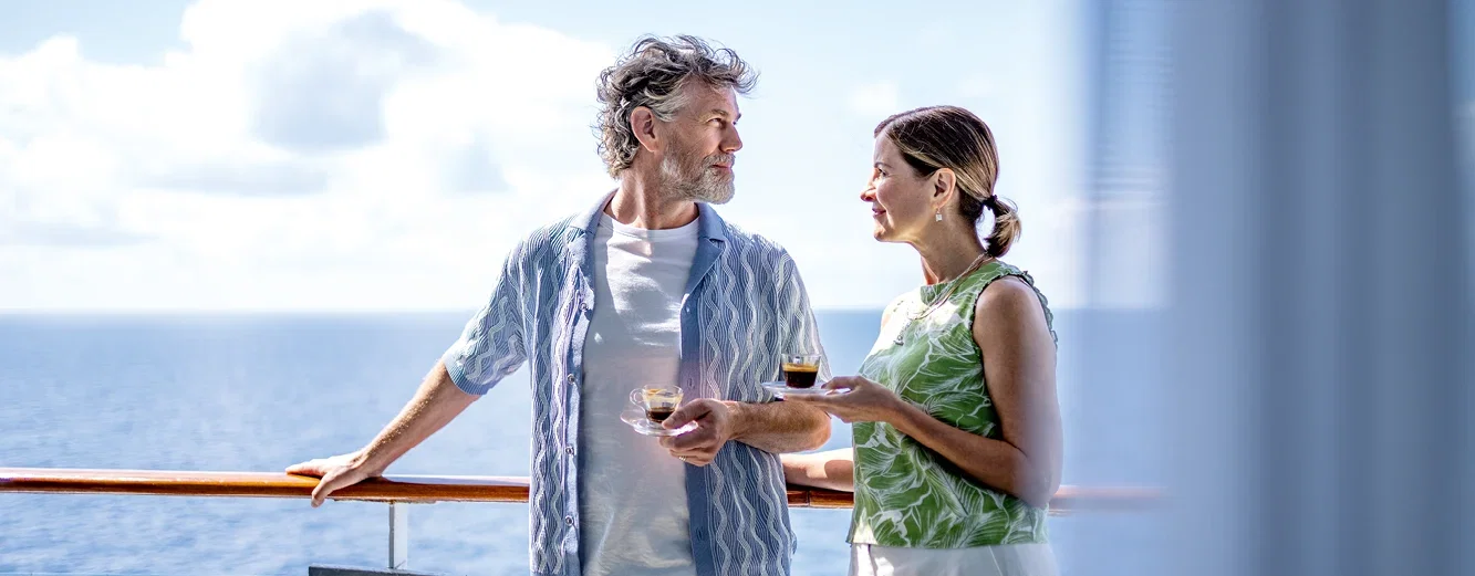 Relaxing on deck with drinks, enjoying ocean views aboard a cruise ship.