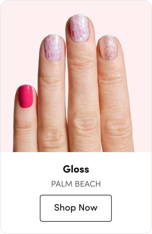 Hand with press-on nails featuring a hot pink accent nail, floral print nails, and a glitter accent nail, labeled 