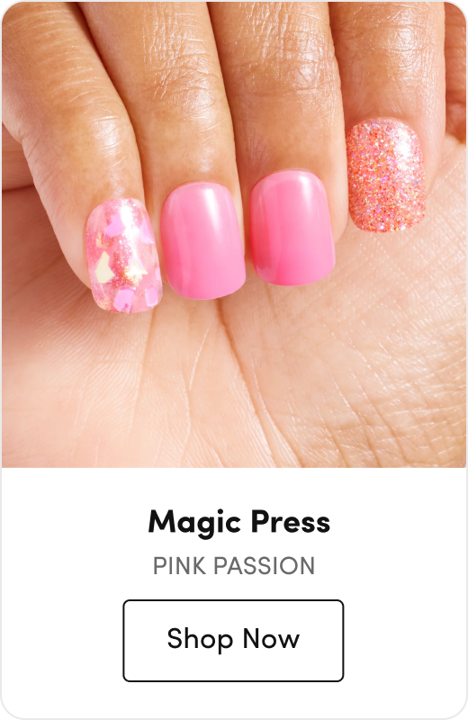 Hand with pink press-on nails featuring a glitter accent nail and a floral confetti accent nail, labeled 