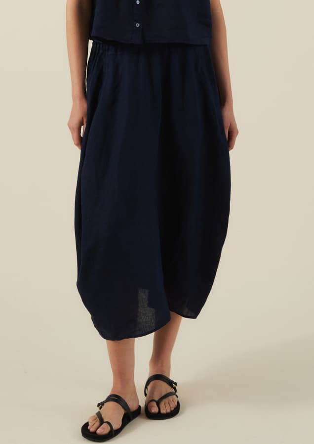 Image shows a model wearing the Fae Skirt in Navy.