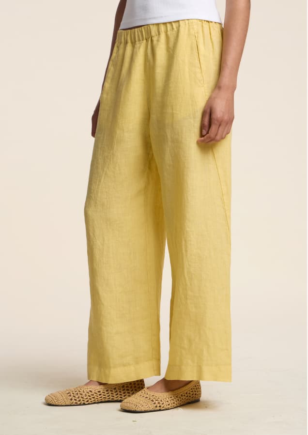 Image shows a model wearing the Lola Pants in Sun.