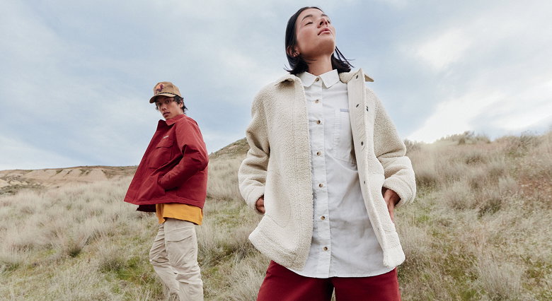 Two people standing in a field