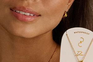 Our Newest Addition, the Birthstone Necklace, being held up by a model