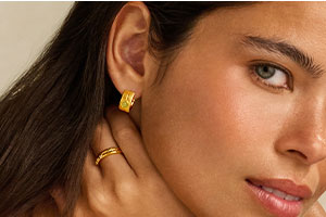 Our Newest Addition, the Birthstone Necklace, being held up by a model