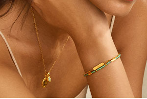 Our Newest Addition, the Birthstone Necklace, being held up by a model