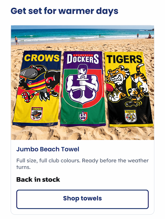 A group of Jumbo AFL Beach Towels Sitting on sand at a beach