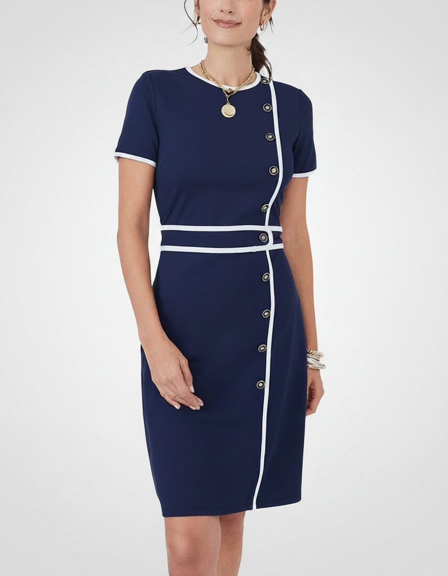 Woman in a navy blue dress with white trim and gold buttons.